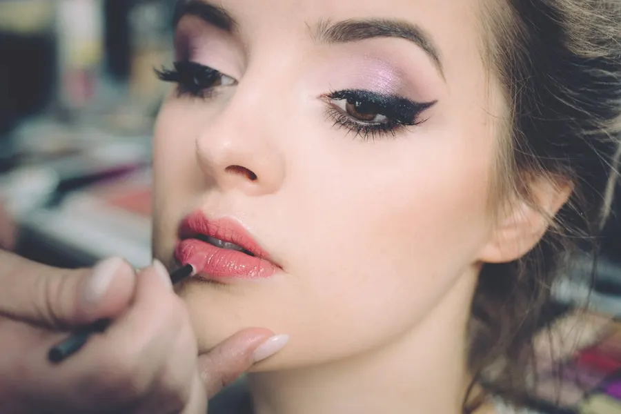 Makeup artist applying eyeliner