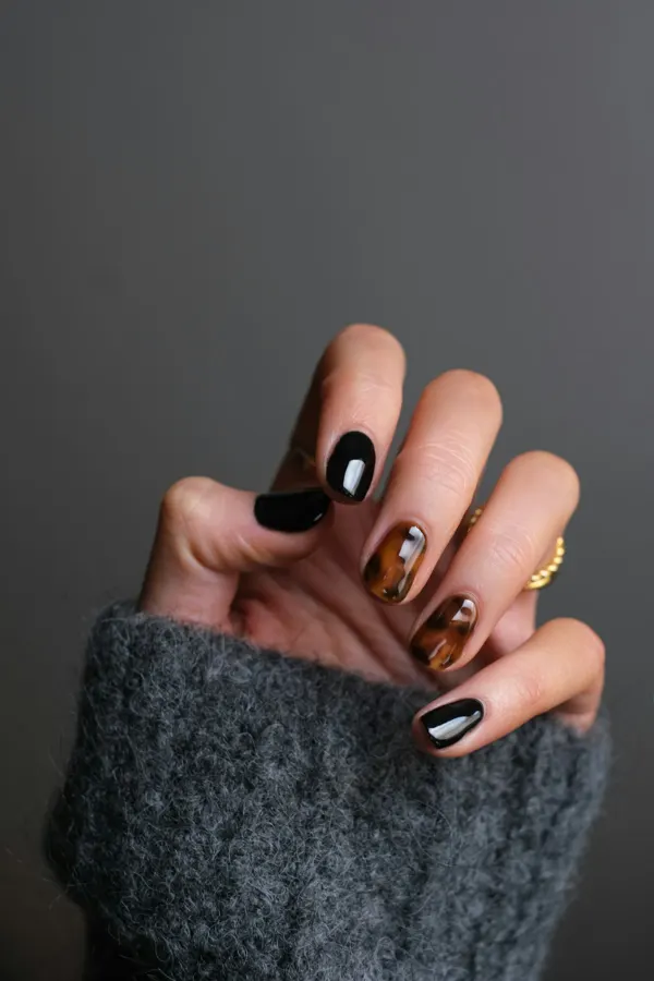 Dark nail art with gold accents